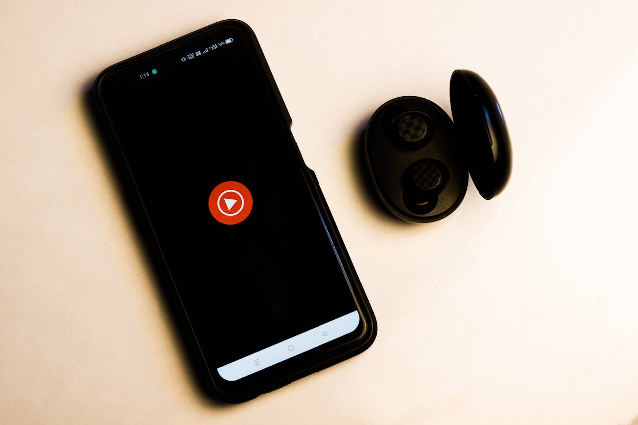 about-img-01 Flat lay of a smartphone and wireless earbuds on a neutral background, ideal for tech and lifestyle themes.